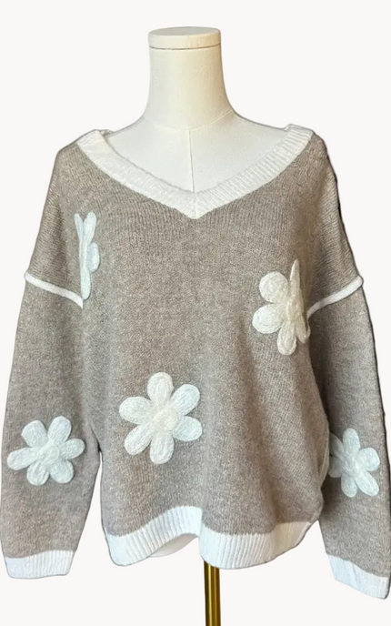 Mocha V-neck drop-shoulder sweater with floral appliqués and contrast trim at neckline, cuffs, and hem, photographed on a Soft Linen background for Justyna Grace Boutique.