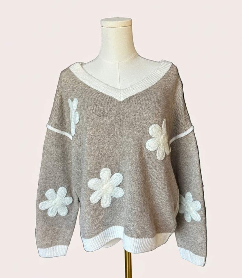 Mocha V-neck drop-shoulder sweater with floral appliqués and contrast trim at neckline, cuffs, and hem, photographed on a Soft Linen background for Justyna Grace Boutique.