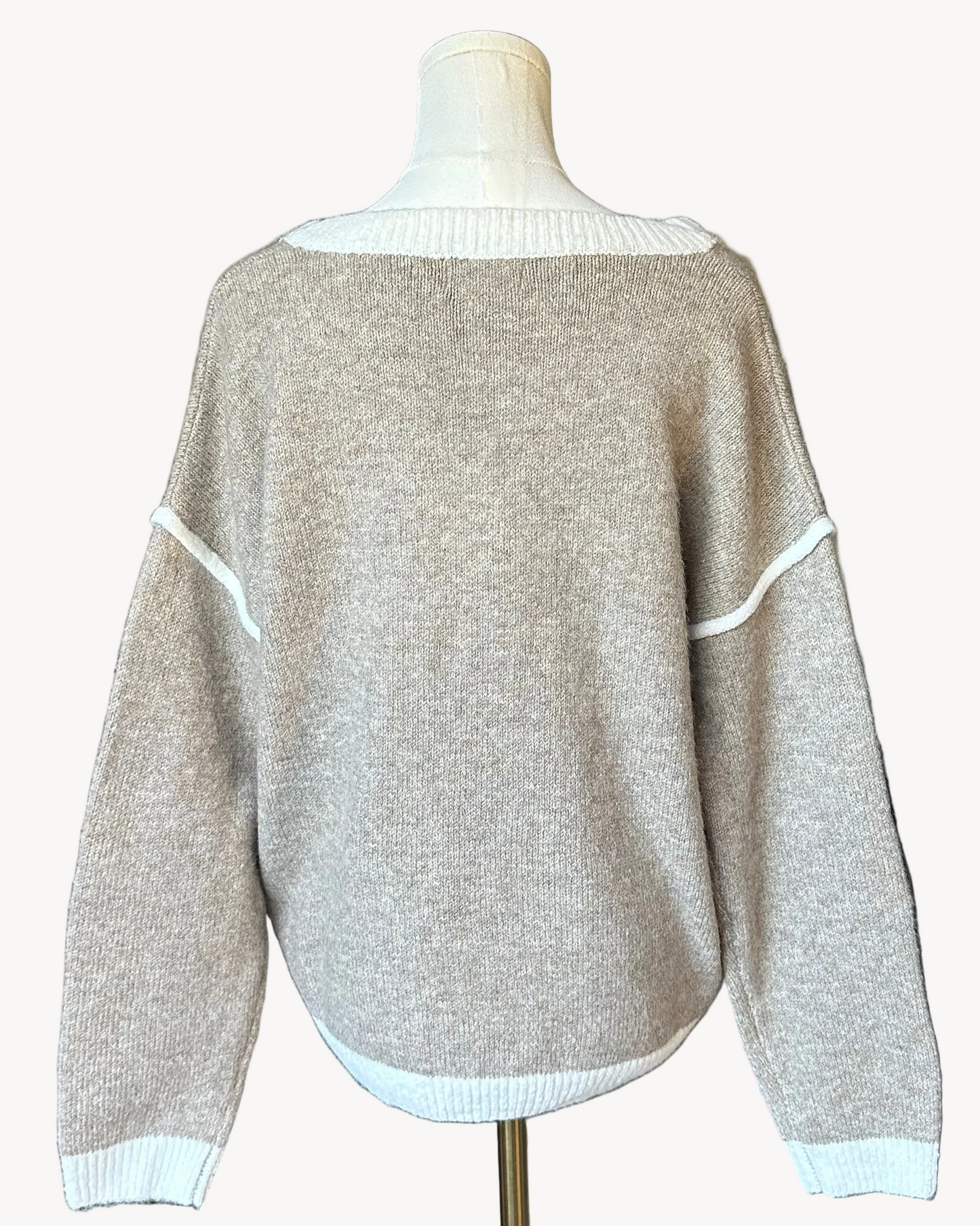 Mocha V-neck drop-shoulder sweater with floral appliqués and contrast trim at neckline, cuffs, and hem, photographed on a Soft Linen background for Justyna Grace Boutique.