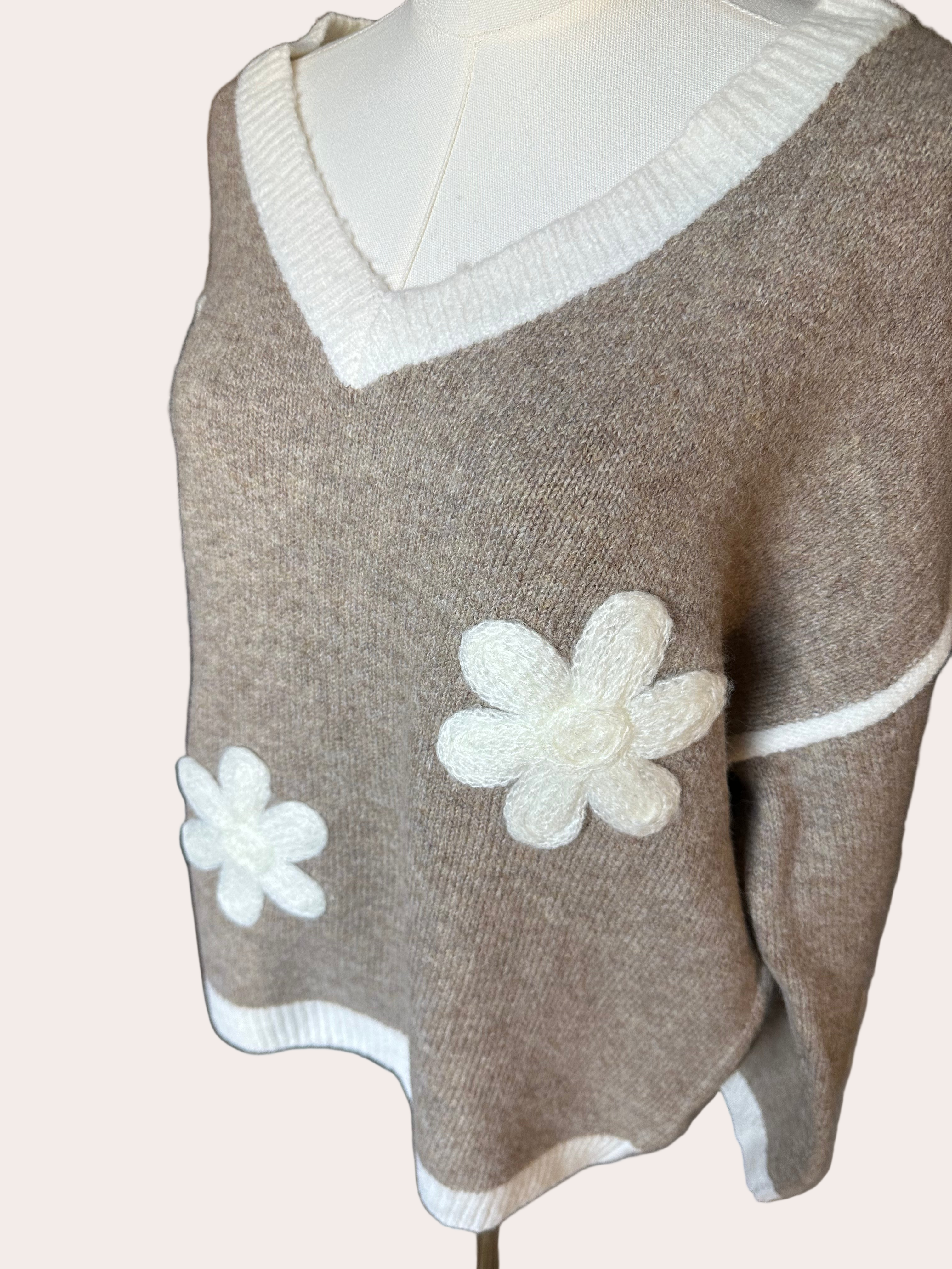 Mocha V-neck drop-shoulder sweater with floral appliqués and contrast trim at neckline, cuffs, and hem, photographed on a Soft Linen background for Justyna Grace Boutique.