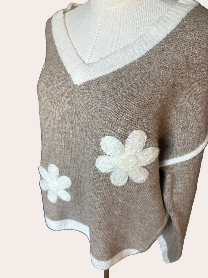 Mocha V-neck drop-shoulder sweater with floral appliqués and contrast trim at neckline, cuffs, and hem, photographed on a Soft Linen background for Justyna Grace Boutique.