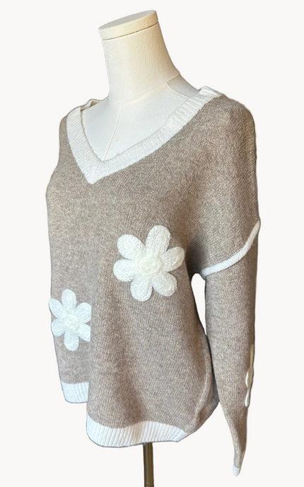 Mocha V-neck drop-shoulder sweater with floral appliqués and contrast trim at neckline, cuffs, and hem, photographed on a Soft Linen background for Justyna Grace Boutique.