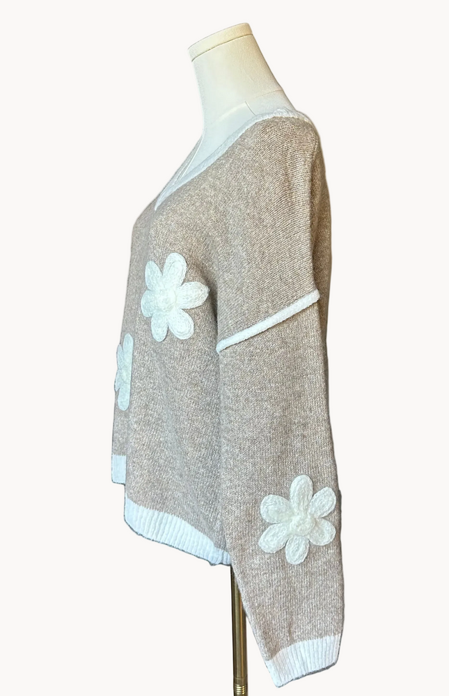 Mocha V-neck drop-shoulder sweater with floral appliqués and contrast trim at neckline, cuffs, and hem, photographed on a Soft Linen background for Justyna Grace Boutique.