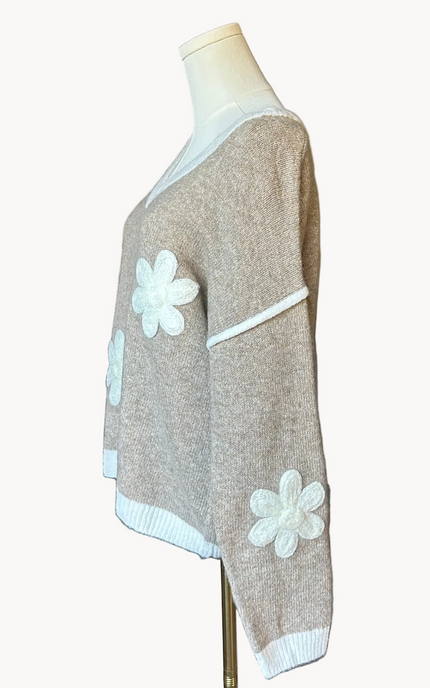 Mocha V-neck drop-shoulder sweater with floral appliqués and contrast trim at neckline, cuffs, and hem, photographed on a Soft Linen background for Justyna Grace Boutique.