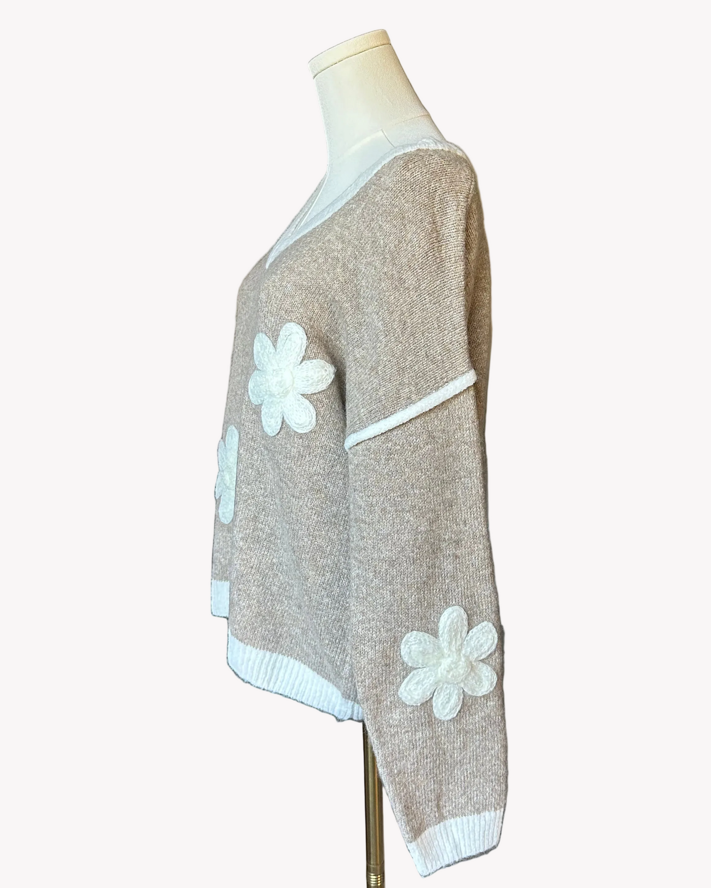 Mocha V-neck drop-shoulder sweater with floral appliqués and contrast trim at neckline, cuffs, and hem, photographed on a Soft Linen background for Justyna Grace Boutique.