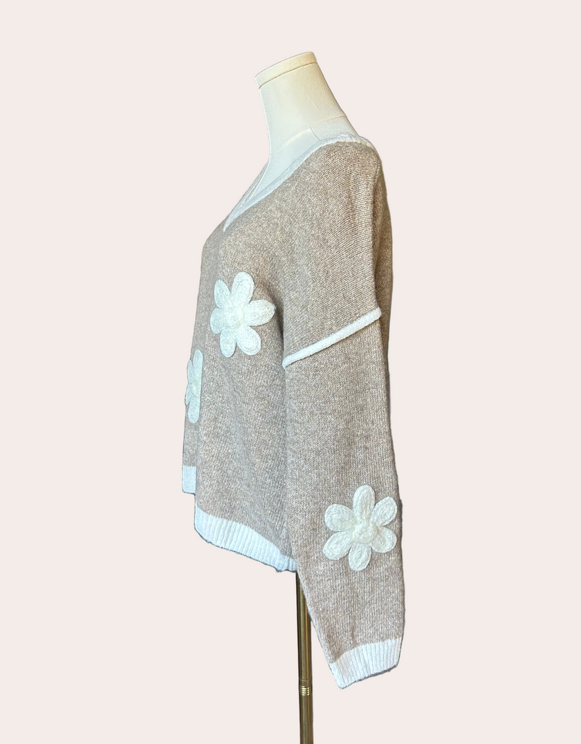 Mocha V-neck drop-shoulder sweater with floral appliqués and contrast trim at neckline, cuffs, and hem, photographed on a Soft Linen background for Justyna Grace Boutique.