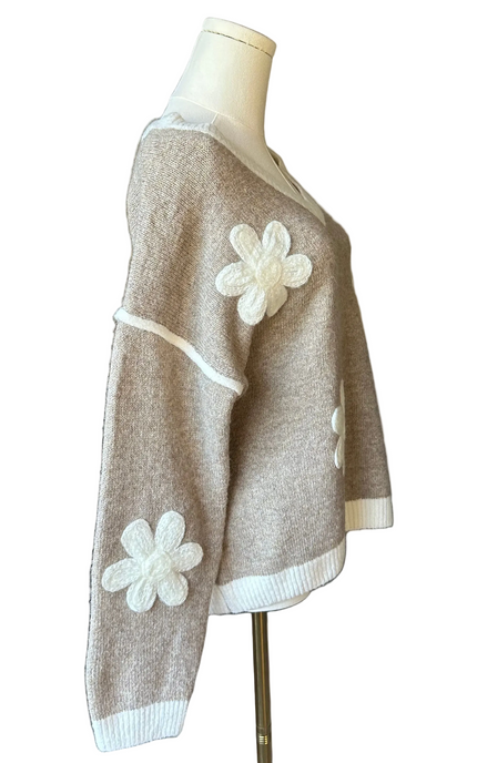 Mocha V-neck drop-shoulder sweater with floral appliqués and contrast trim at neckline, cuffs, and hem, photographed on a Soft Linen background for Justyna Grace Boutique.
