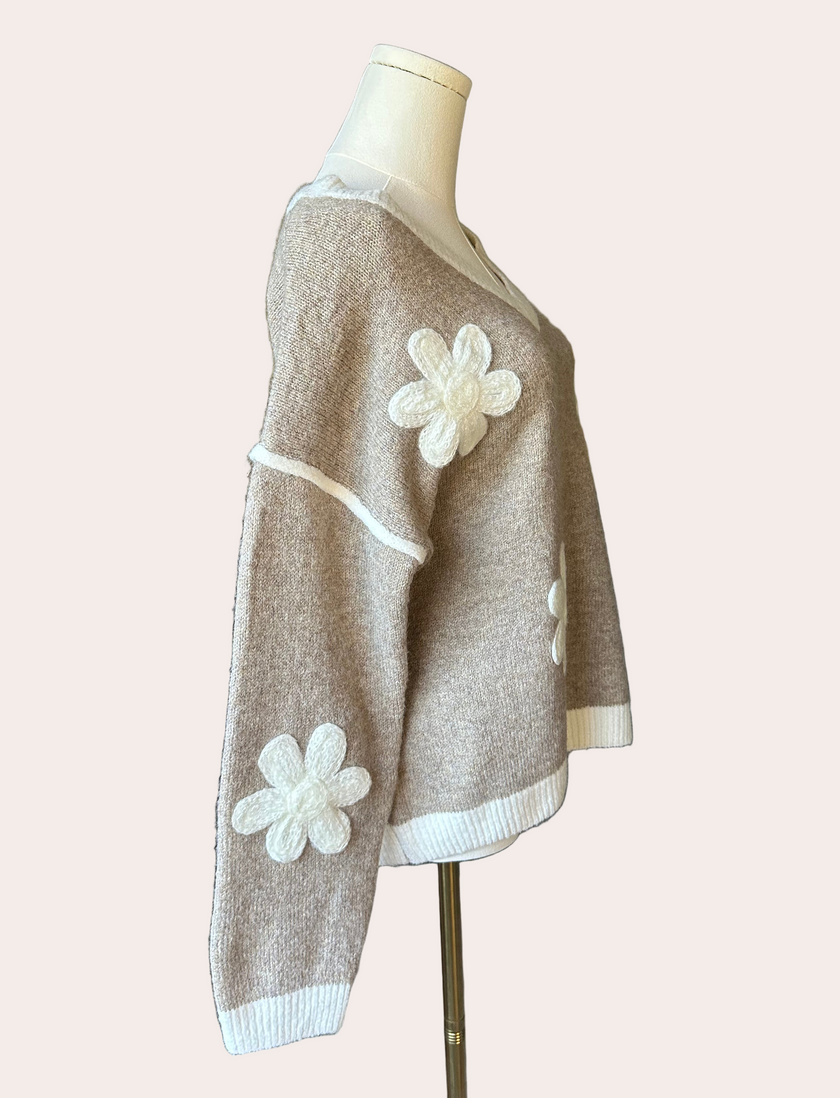 Mocha V-neck drop-shoulder sweater with floral appliqués and contrast trim at neckline, cuffs, and hem, photographed on a Soft Linen background for Justyna Grace Boutique.