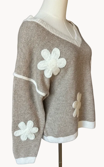 Mocha V-neck drop-shoulder sweater with floral appliqués and contrast trim at neckline, cuffs, and hem, photographed on a Soft Linen background for Justyna Grace Boutique.