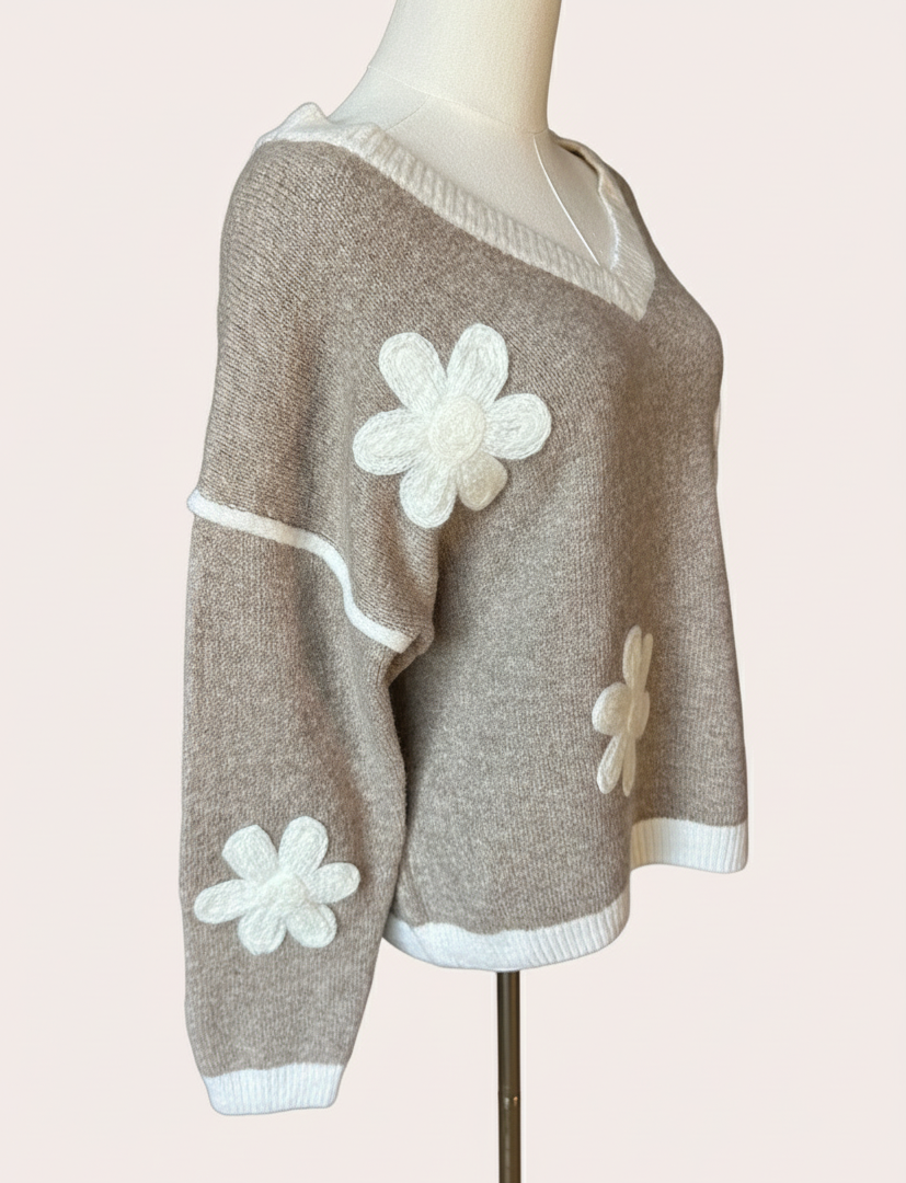 Mocha V-neck drop-shoulder sweater with floral appliqués and contrast trim at neckline, cuffs, and hem, photographed on a Soft Linen background for Justyna Grace Boutique.