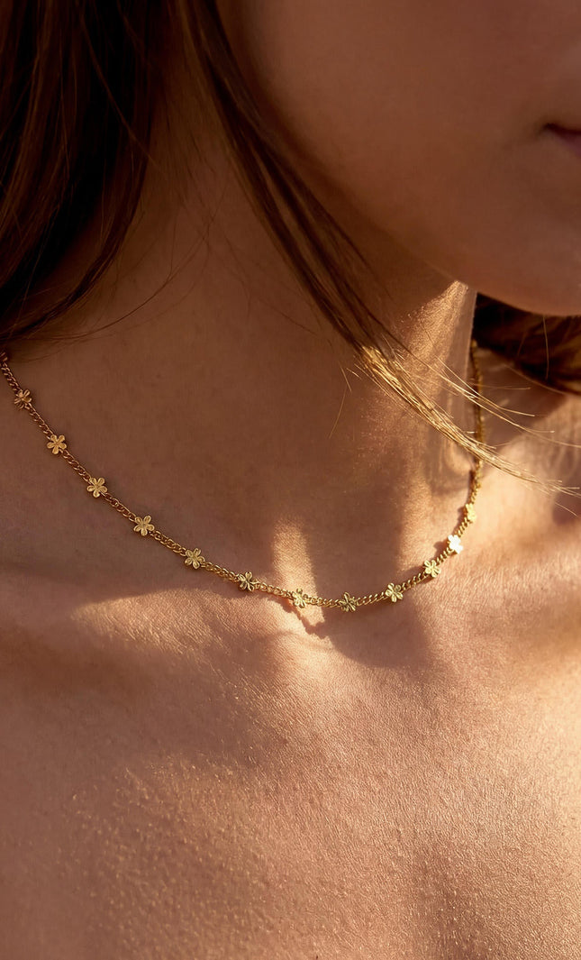 Delicate daisy necklace on model in motion, demonstrating lightweight comfort