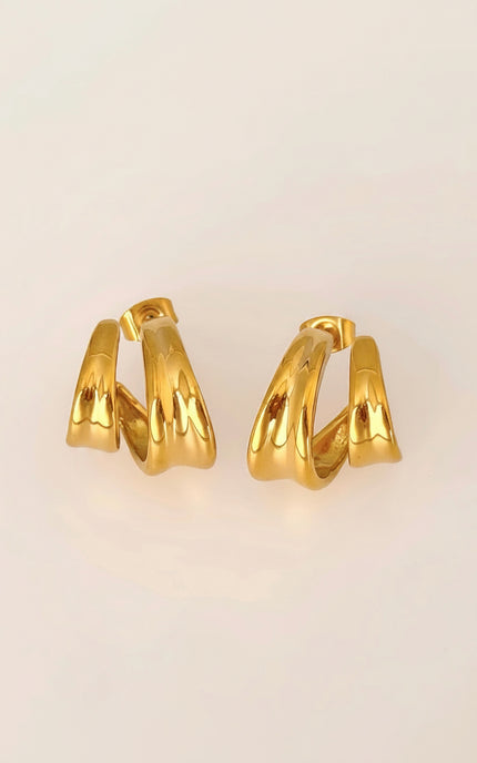 Flat lay of double twist hoop earring pair in 18k gold PVD over 316L stainless steel