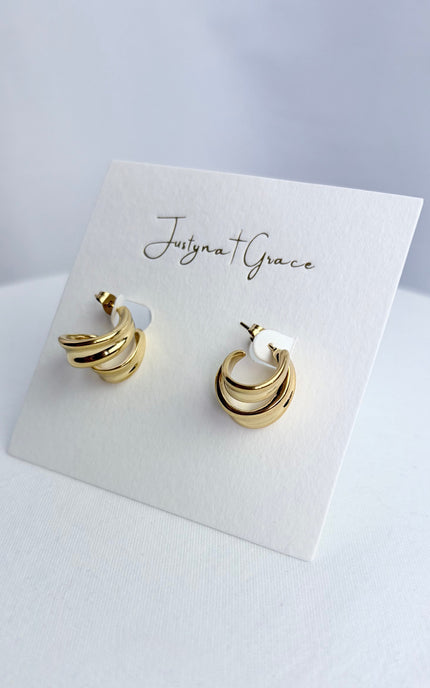 Side profile of double twist gold hoop earring showing dimensional twist detail and sculpted silhouette