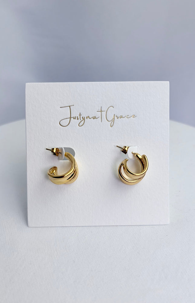 Double twist hoop earrings in 18k gold PVD over 316L stainless steel with sculpted dimensional design