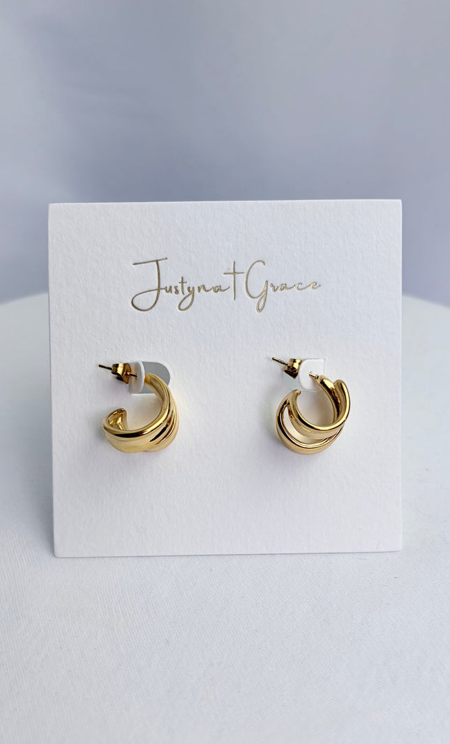 Double twist hoop earrings in 18k gold PVD over 316L stainless steel with sculpted dimensional design