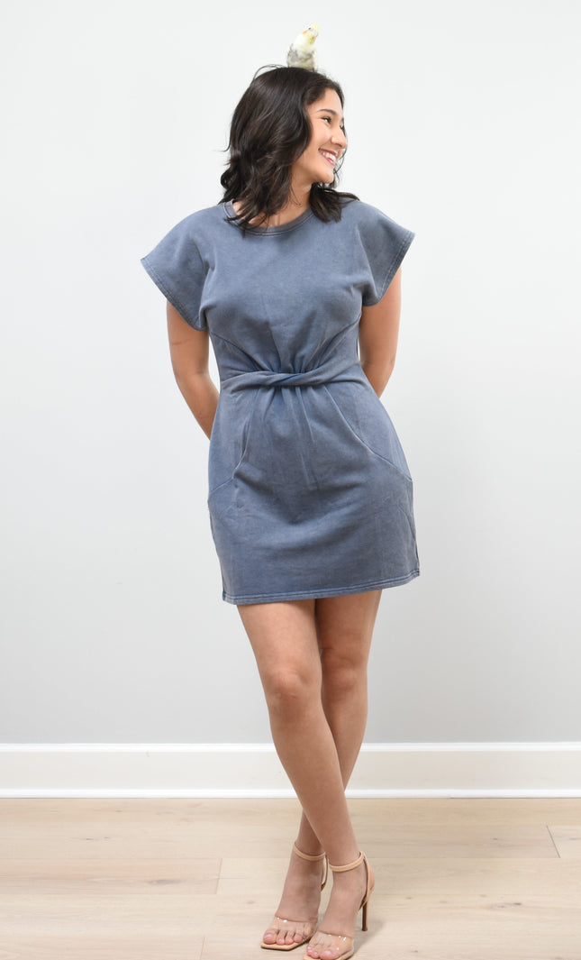 Woman wearing a blue dress against a white background