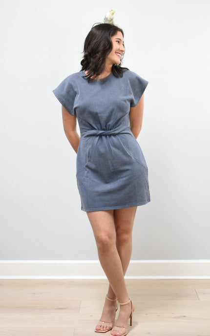 Woman wearing a blue dress against a white background