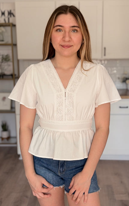 Elise eyelet cotton blouse front view with V neckline and button down detail