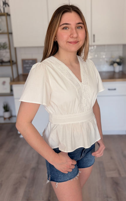 Elise eyelet cotton blouse front view with V neckline and button down detail