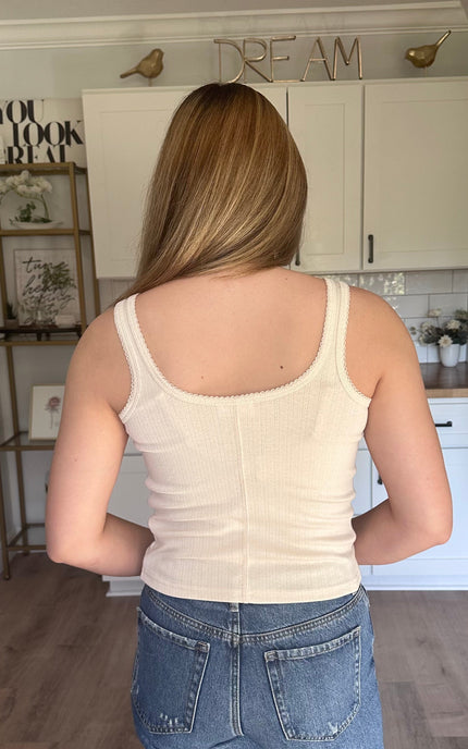 Cream sleeveless pointelle tank with fitted silhouette