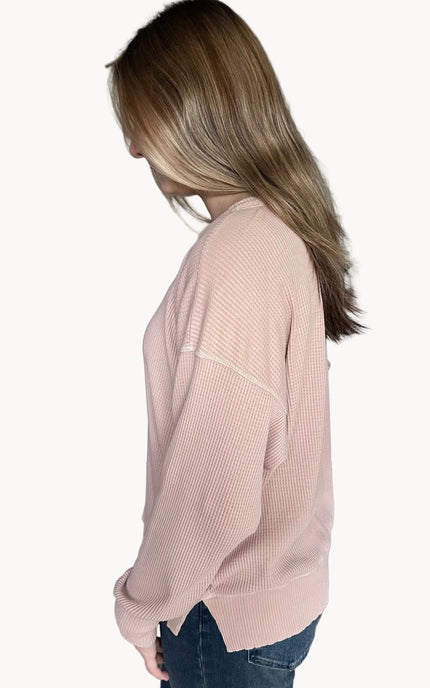 Side view of the Eliza knit top highlighting subtle drop shoulders and side slit detail