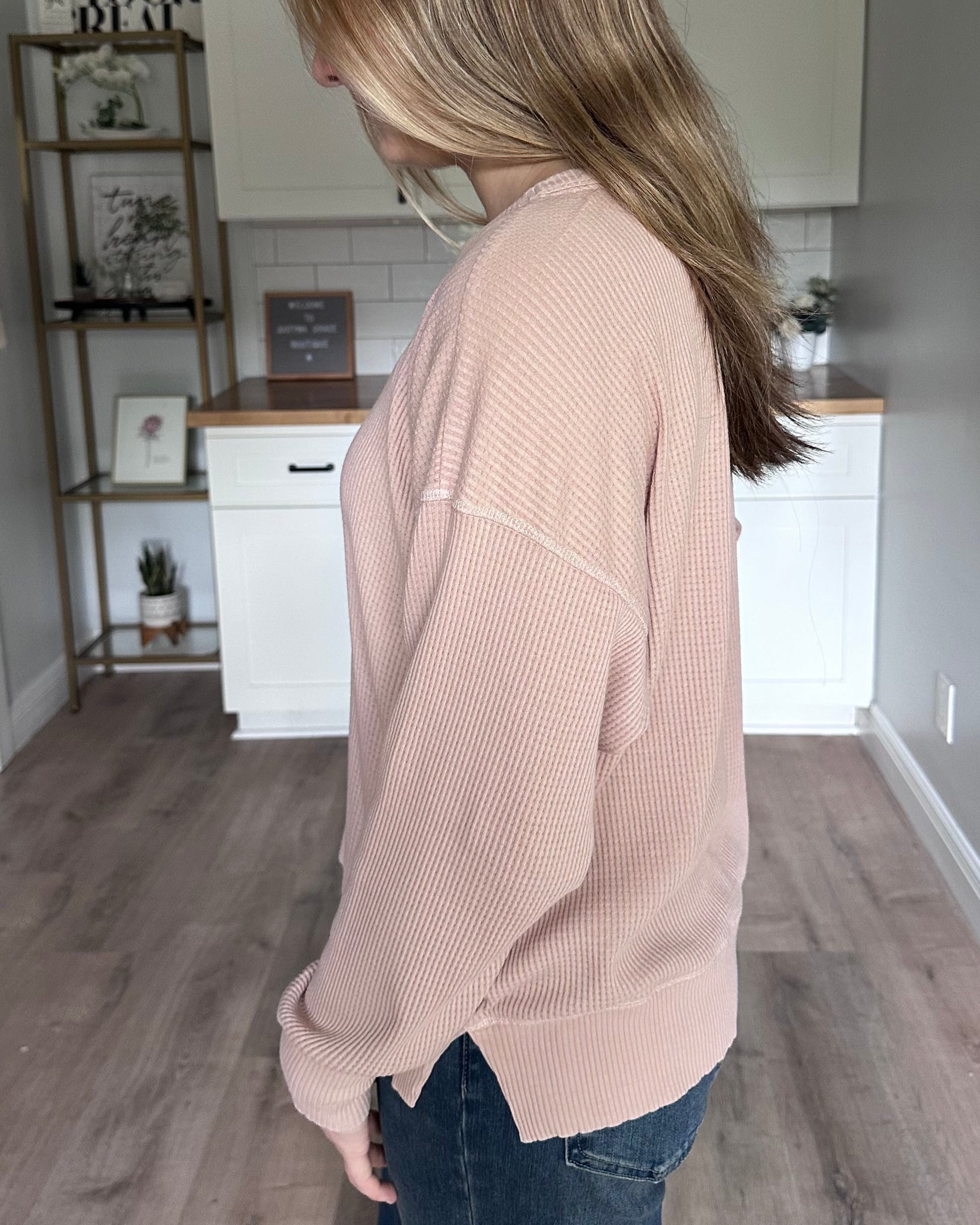 Side view of the Eliza knit top highlighting subtle drop shoulders and side slit detail