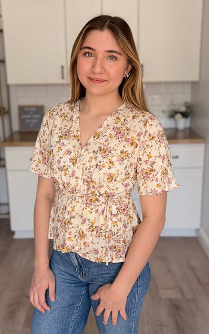 Emilia floral wrap blouse front view with soft floral print and wrap bodice