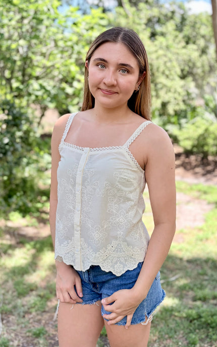 A 5'7" model wearing a size small 100% cotton eyelet top, demonstrating the lightweight and breathable fit.