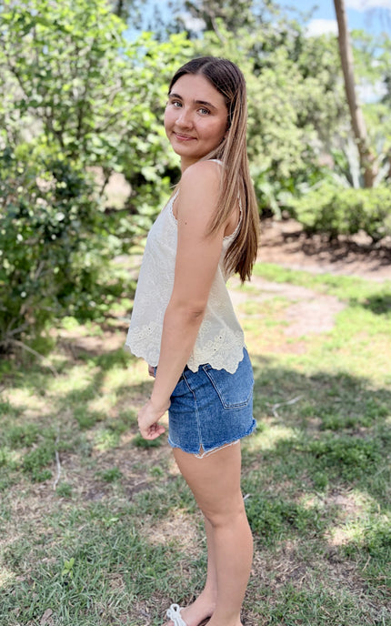 A 5'7" model wearing a size small 100% cotton eyelet top, demonstrating the lightweight and breathable fit.