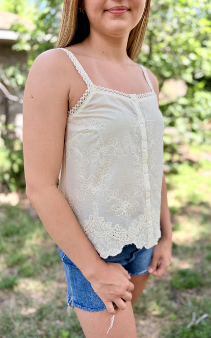 Detail view of the functional button-front closure and square neckline on a romantic style summer tank.