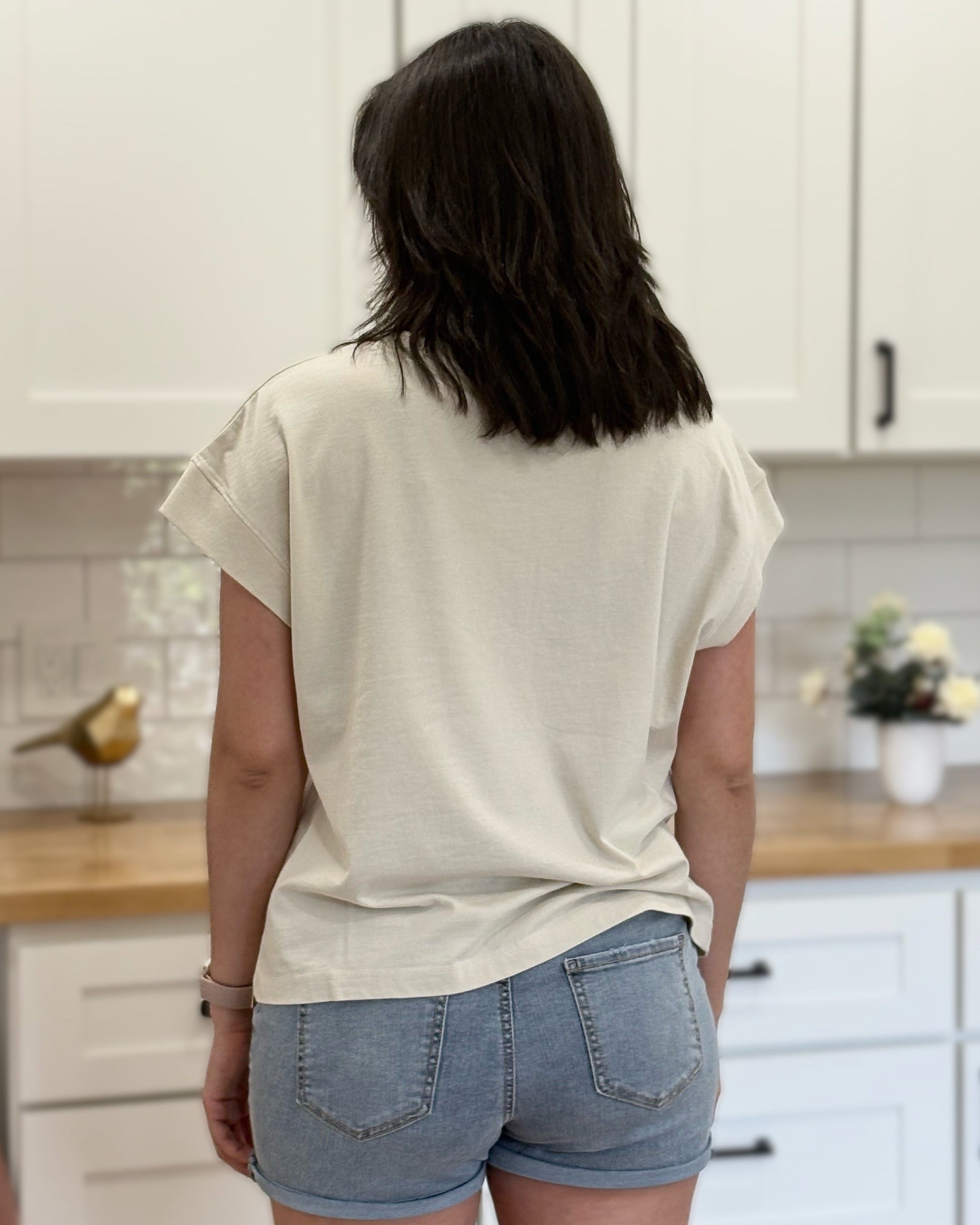 Cream graphic tee with blue faith-inspired design, ethically made and styled for a relaxed fit.