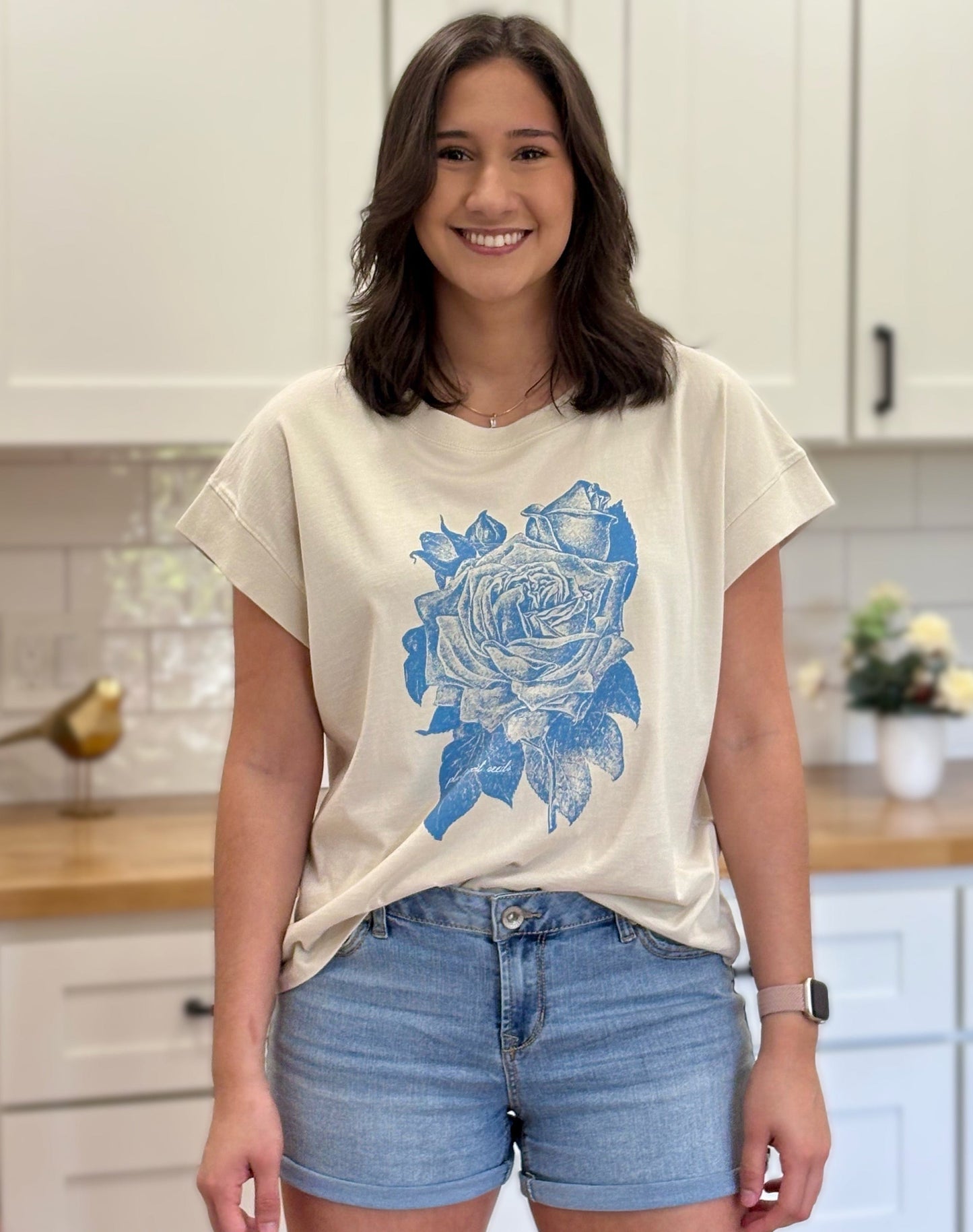 Cream graphic tee with blue faith-inspired design, ethically made and styled for a relaxed fit.