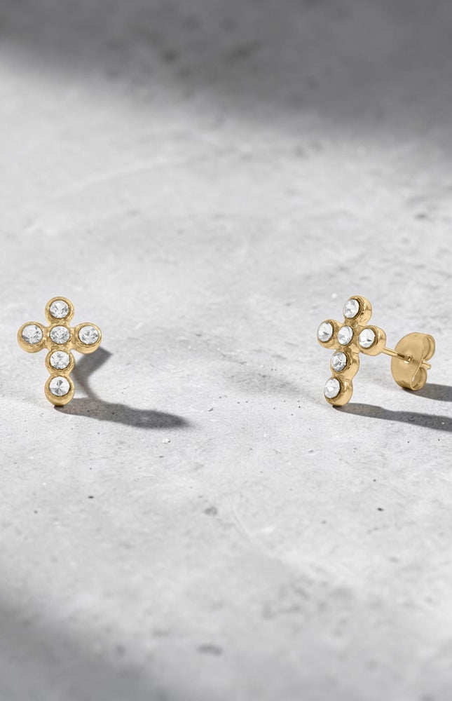 Pair of Faith Cross Stone Stud Earrings displayed separately on white background to show individual earring detail, cross silhouette, and cubic zirconia stone sparkle