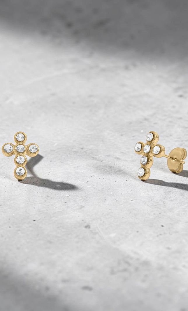 Pair of Faith Cross Stone Stud Earrings displayed separately on white background to show individual earring detail, cross silhouette, and cubic zirconia stone sparkle