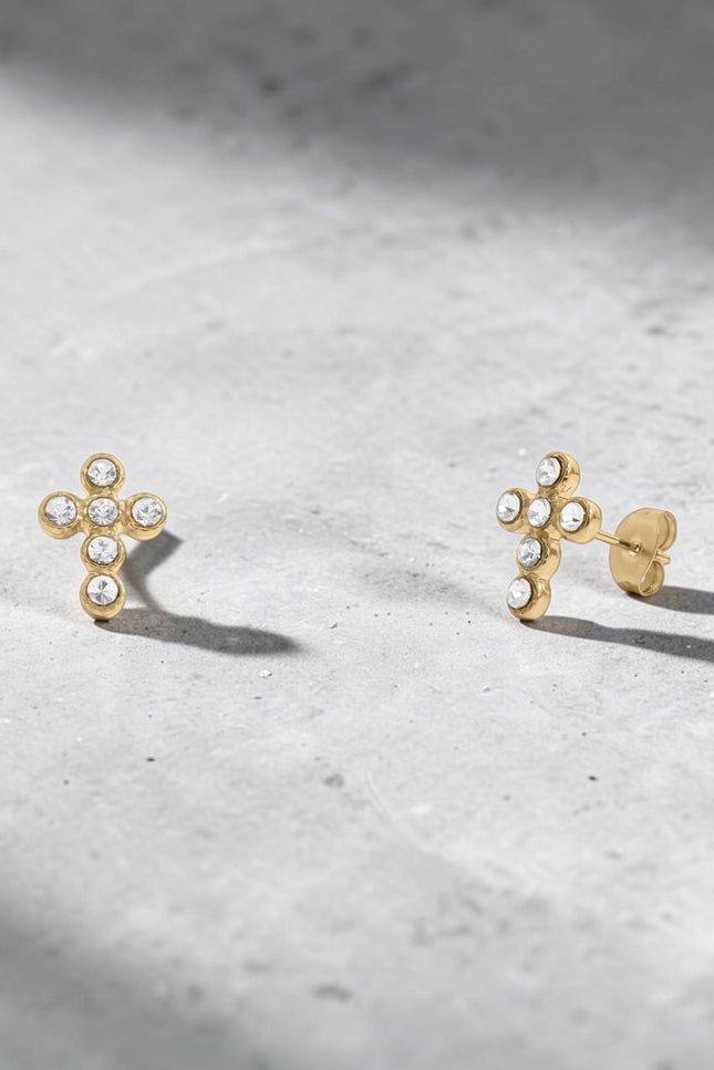 Pair of Faith Cross Stone Stud Earrings displayed separately on white background to show individual earring detail, cross silhouette, and cubic zirconia stone sparkle