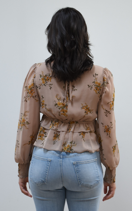 Floral Drift Blouse on soft linen background, featuring a delicate floral print and lightweight chiffon fabric.