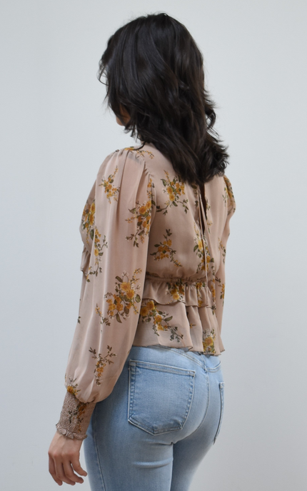 Floral Drift Blouse on soft linen background, featuring a delicate floral print and lightweight chiffon fabric.