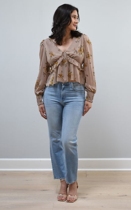 Floral Drift Blouse on soft linen background, featuring a delicate floral print and lightweight chiffon fabric.