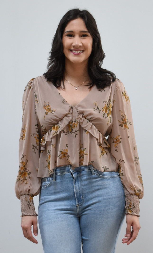 Floral Drift Blouse on soft linen background, featuring a delicate floral print and lightweight chiffon fabric.