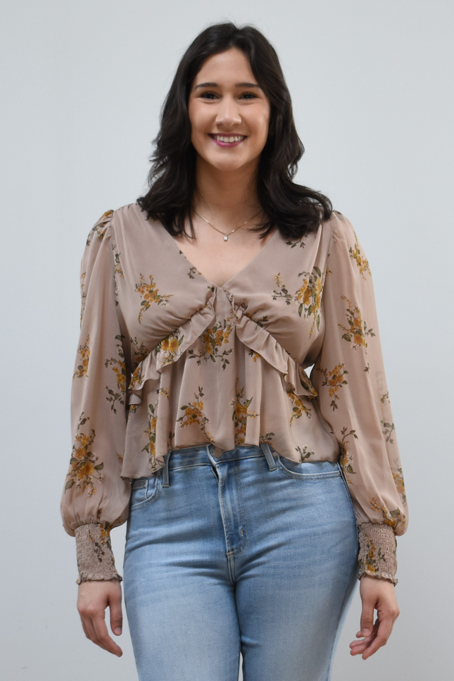 Floral Drift Blouse on soft linen background, featuring a delicate floral print and lightweight chiffon fabric.