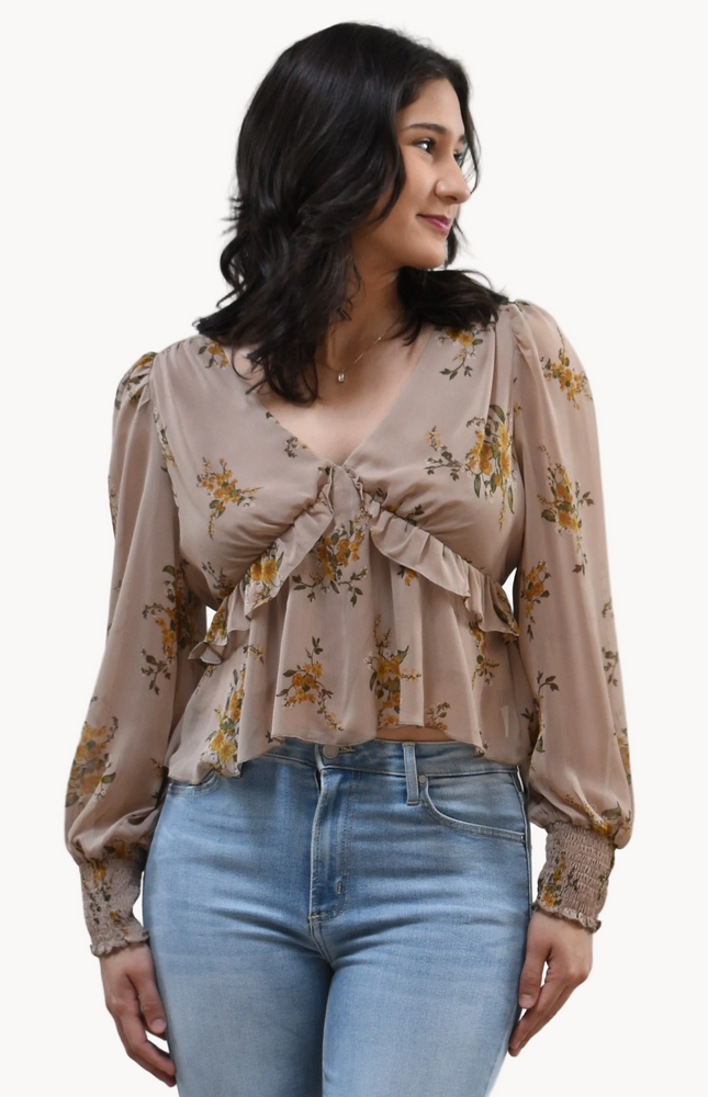 Floral Drift Blouse on soft linen background, featuring a delicate floral print and lightweight chiffon fabric.
