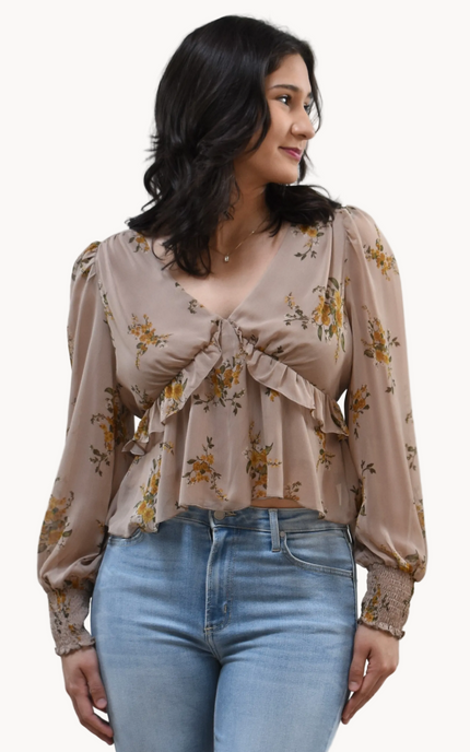 Floral Drift Blouse on soft linen background, featuring a delicate floral print and lightweight chiffon fabric.