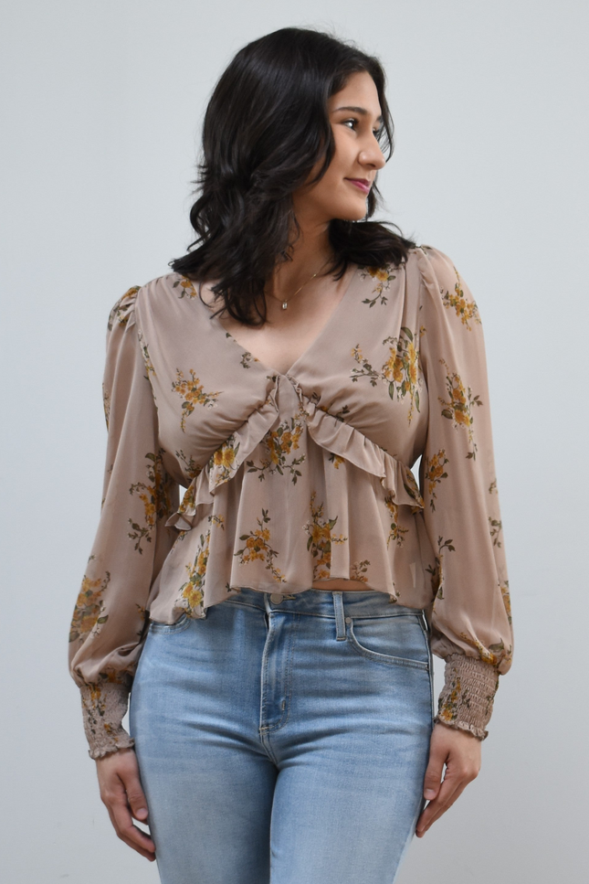 Floral Drift Blouse on soft linen background, featuring a delicate floral print and lightweight chiffon fabric.