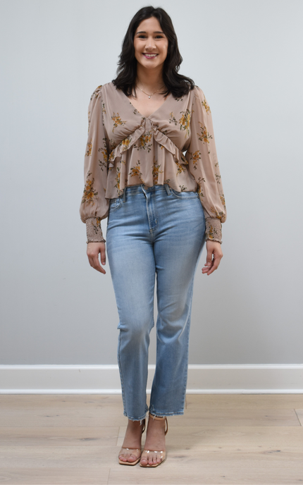 Floral Drift Blouse on soft linen background, featuring a delicate floral print and lightweight chiffon fabric.