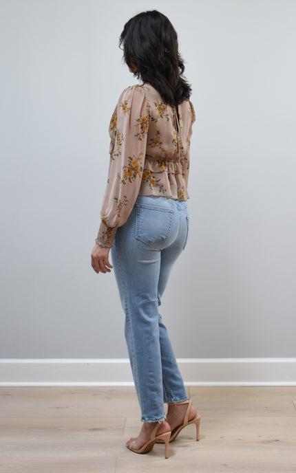 Floral Drift Blouse on soft linen background, featuring a delicate floral print and lightweight chiffon fabric.