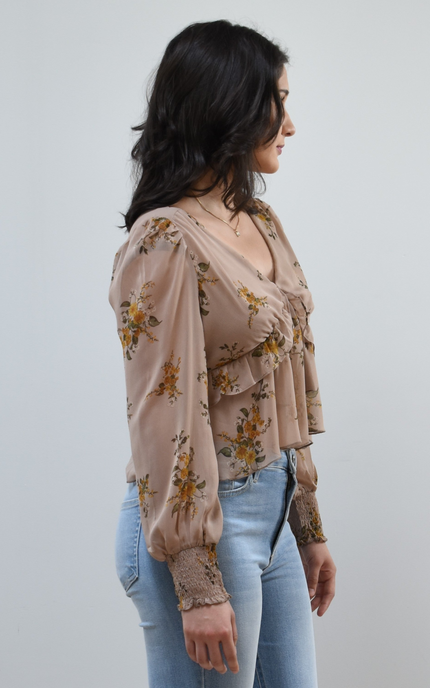 Floral Drift Blouse on soft linen background, featuring a delicate floral print and lightweight chiffon fabric.
