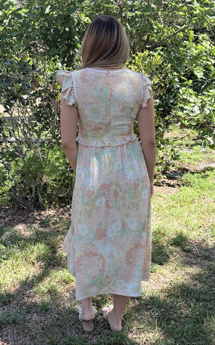 Back view of floral midi dress showing flutter sleeves and ruffled detail