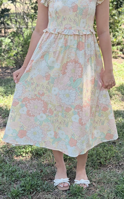 Full outfit shot of woman in floral midi dress, demonstrating brunch-to-evening versatility