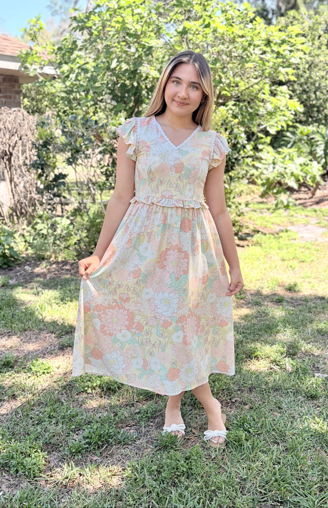Flutter sleeves in motion on woman wearing lightweight romantic floral midi dress