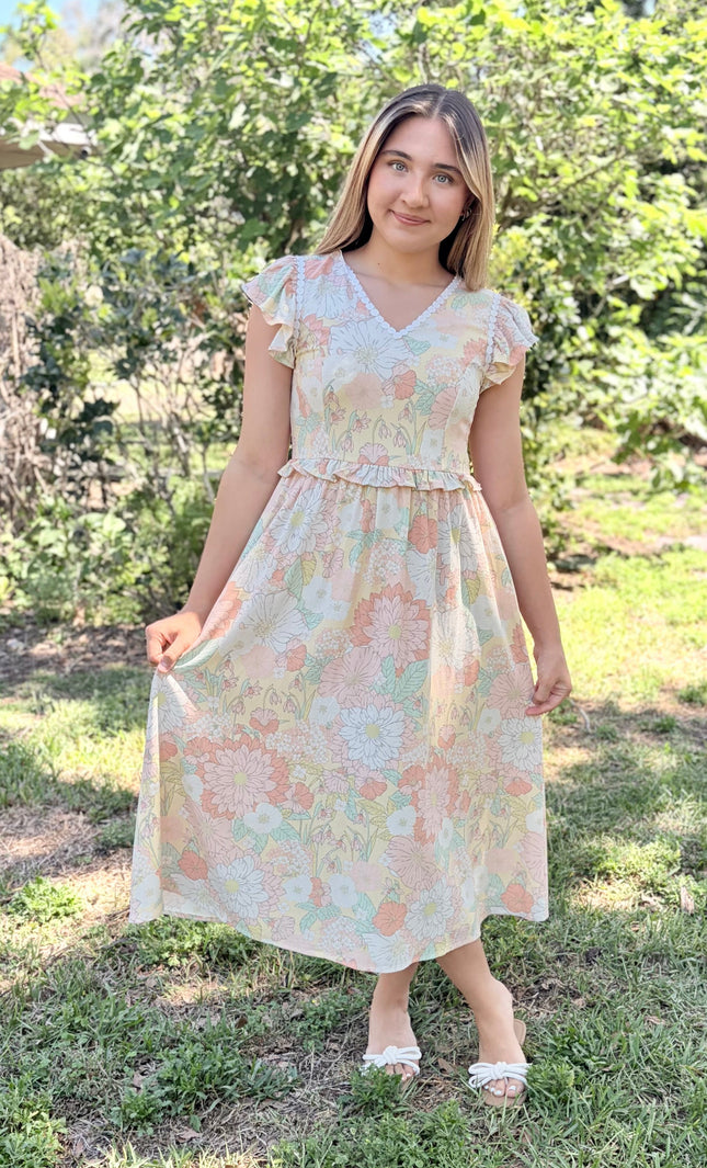 Flutter sleeves in motion on woman wearing lightweight romantic floral midi dress